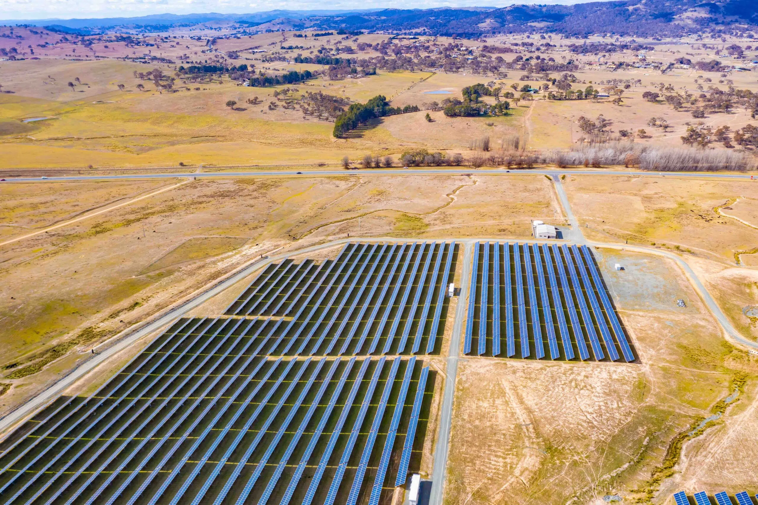 Aerial view of a large solar farm for renewable energy supply in Canberra, Australia on a countryside landscape background